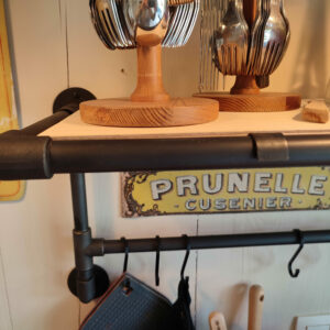 Black patina on an industrial shelf with a steel plumbing fitting